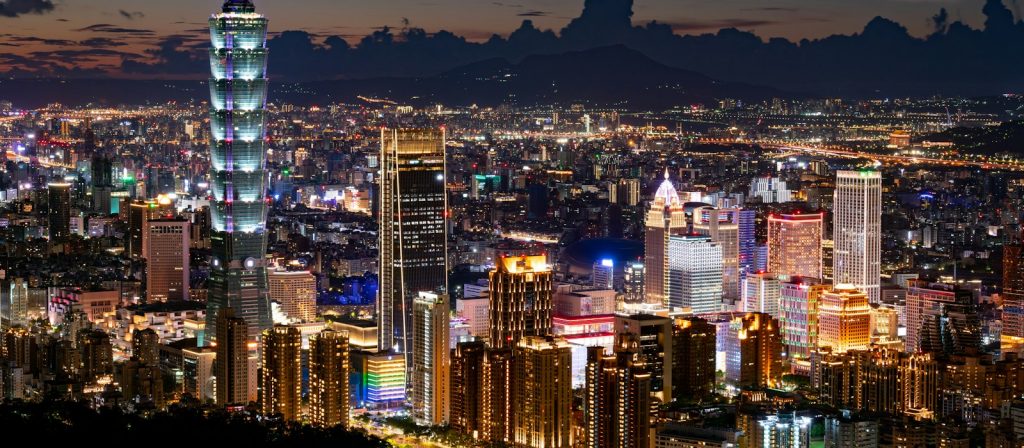 the Taipei skyline at night, lit from the river out to the hills