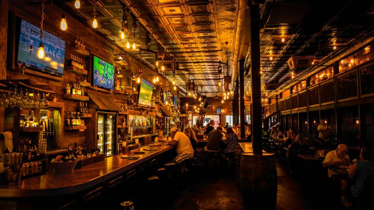 people sitting and eating inside a bar