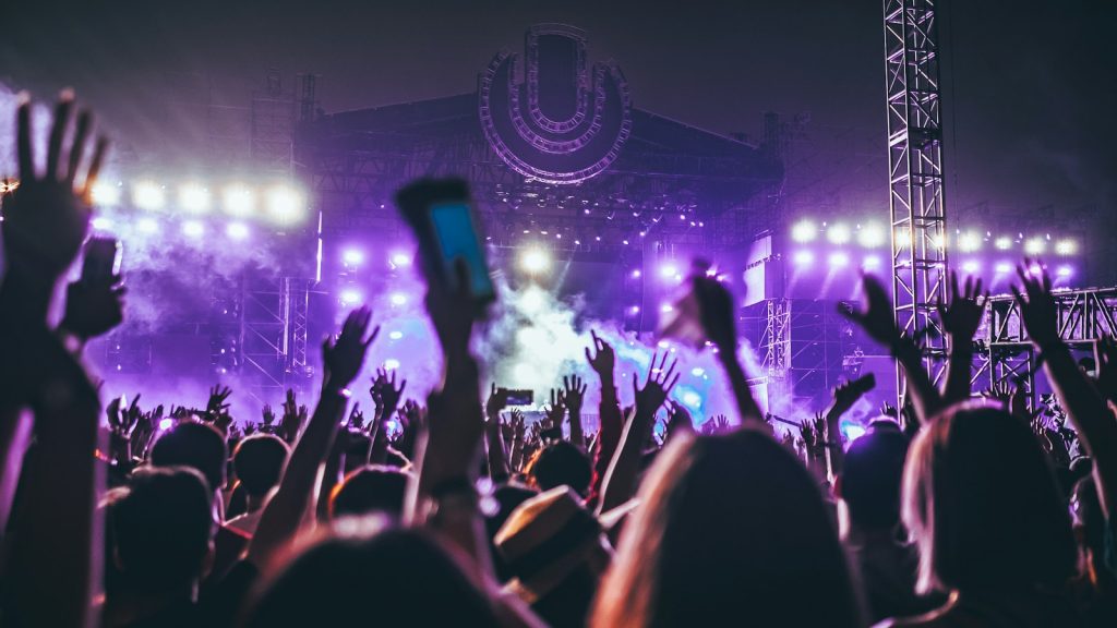 crowd raising their hands at a concert