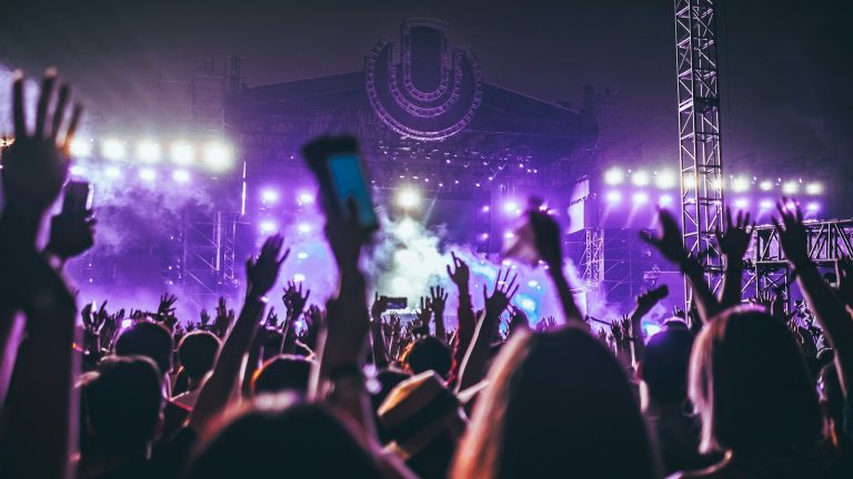 crowd raising their hands at a concert