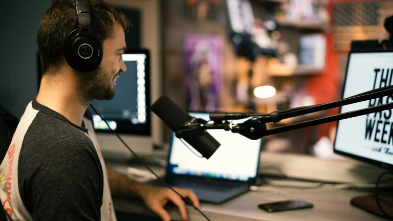 man in a collared shirt wearing black headphones