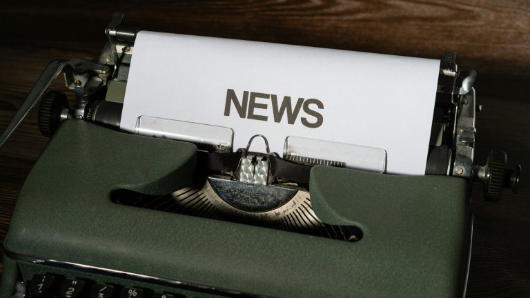 typewriter with a sheet reading NEWS