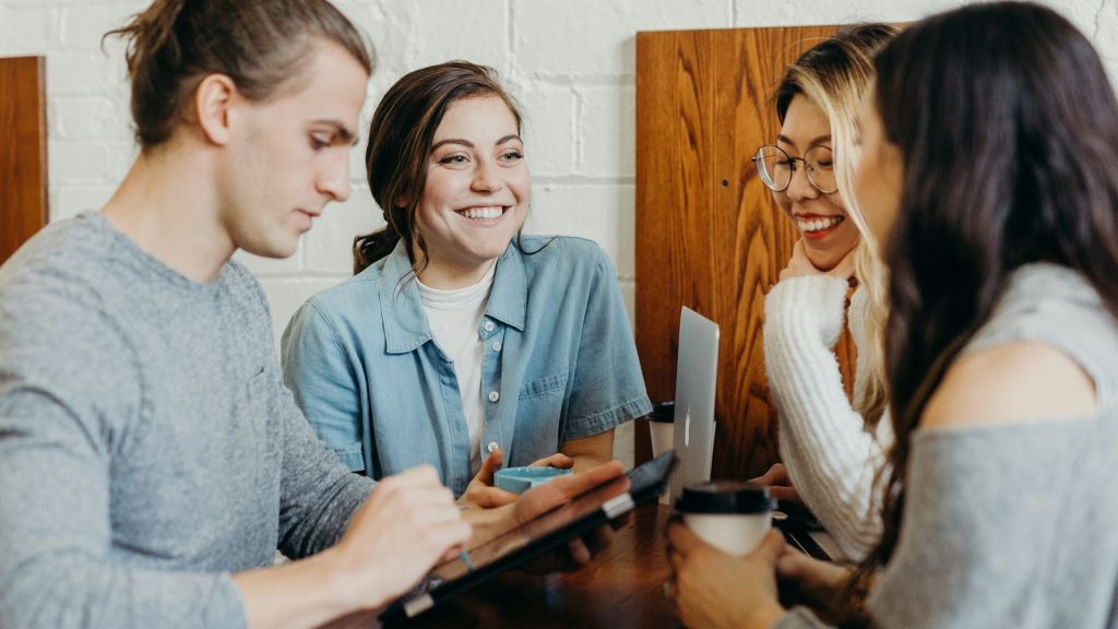 a group of friends talking at a coffee shop