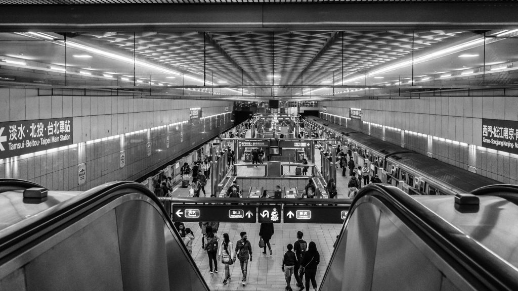 people walking through a metro station