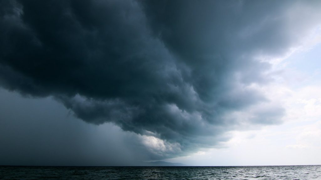 storm front moving across the sky over water