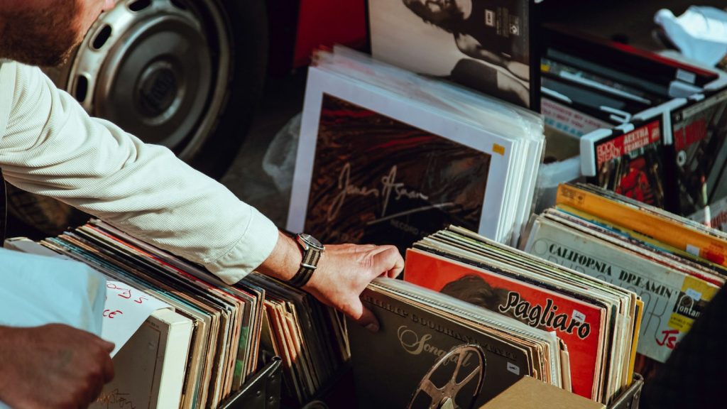 person flipping through vinyl records